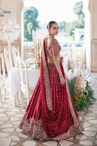 Keep it dreamy and classic with the best DeemasFashion reception wear! The handsome deep red outfit with blouse and lehenga is gracefully embellished with silver embroidery that gives you a head-turning appearance on the wedding day. The blouse is enhanced with tilla, dabka, kora, Kundan and crystals. The round neckline of the blouse makes this glamorous attire an epitome of royalty and grace. Luxury designs on half sleeves add super beauty to the outfit. It is organized with a lehenga adorned with embroidery to make your day charming. Finish this outfit with a dupatta embellished with four-sided borders and which is sprinkled with sequins all over.