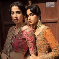 Keep it comfy and attractive with the best DeemasFashion reception wear! A silver flare lehenga encrusted with tilla, dabka, kora, Kundan and pearl work with heavily adorned silver and golden embroidery. The border of the lehenga has a beautiful red border to make it a unique masterpiece. The red blouse with V shape neckline is hand rendered with beautiful embroidery. In addition to this, the following blouse has half sleeves which is a simply stunning wedding dress. The look is completed with a beautiful, red organza dupatta with intricately hand embellished motifs and borders.