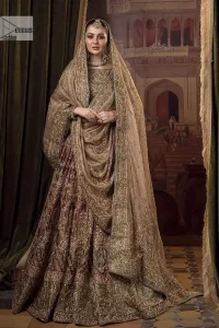 This alluring outfit is surely any girl’s dream. The hazel blouse is a magnificent choice which is ornamented with golden embroidery that wins everyone's hearts at the very first glance. It is further intensified with tilla, dabka, kora, Kundan and stones. Hand-crafted details on the full sleeves of this beautiful nikah dress make it the epitome of beauty. It is coordinated with a lehenga which is decorated with the finest details that are your first priority for the wedding. The lehenga has a huge flare to fulfil the dreamy look. Complete this article with a dupatta that is adorned with four-sided embellished borders and sparkling sequins to make your day.