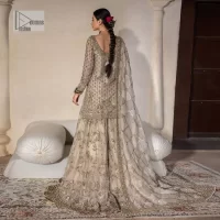 Unravel your inner density with our ivory nikah outfit. DeemasFashion presents this outfit which is embellished with light golden embroidery that further intensifies with tilla, dabka, kora, Kundan and the real magic of Zardozi. The ivory short shirt has boat shape neckline that is the epitome of royalty and grace. In addition to this, the embellished full sleeves also give a stunning touch to the shirt. It is coordinated with scalloped sharara making it a perfect choice to pair with the short shirt. Finish this outfit with a dupatta framed with four-sided embellished borders that gives you an impressive appearance on the Big day.