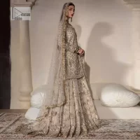 Unravel your inner density with our ivory nikah outfit. DeemasFashion presents this outfit which is embellished with light golden embroidery that further intensifies with tilla, dabka, kora, Kundan and the real magic of Zardozi. The ivory short shirt has boat shape neckline that is the epitome of royalty and grace. In addition to this, the embellished full sleeves also give a stunning touch to the shirt. It is coordinated with scalloped sharara making it a perfect choice to pair with the short shirt. Finish this outfit with a dupatta framed with four-sided embellished borders that gives you an impressive appearance on the Big day.