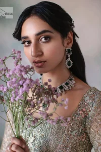 Unique embroidery designs to add some sparkle to your style on your Nikah! Light blue angrakha maxi with delicate multiple colour embroideries and intricate hand embellishments of tilla, dabka, kora, Kundan and crystals on the classic silhouette. Designed to flaunt your best features, the full sleeves carry beautiful embroidery with a square neckline. The following maxi along with the back train lehenga gives this outfit a unique look. Paired with a dreamy dupatta framed with embellished borders, this look is the epitome of ethereal and easy elegance.