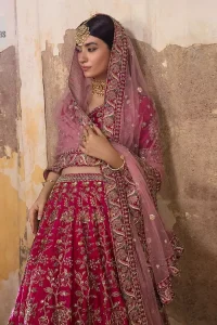 Blissful Pink! This ensemble is the epitome of grace. A shocking pink lehenga is heavily adorned with floral patterns. The flare of the lehenga gives a ravishing finishing look to this party wear. A beautiful blouse in the graceful shocking pink shade is an exquisite choice to pair with Lehenga. This choli is hand-embellished with lavish details of golden embroidery which is highlighted with dabka, tilla, kora, Kundan and details of Resham. Floral designs on half sleeves give a beautiful traditional touch to the masterpiece. It is paired up with a dupatta embellished with four-sided borders and tiny floral motifs all over.