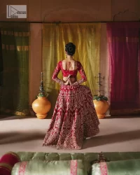 We are Introducing a wine red blouse and lehenga to our wide range of charming bridal dresses. The Pakistani reception Lehenga is an amalgamation of contemporary and traditional art which is decorated with golden embroidery. The embroidery is further enhanced with tilla, dabka, kora, Kundan and detailing of zardozi. It is paired up with a wine red blouse which is adorned with tiny floral motifs. The full sleeves of the blouse are heavily embellished to increase the beauty of the outfit. Further, the square neckline makes this blouse a unique masterpiece. Finish this with a dupatta with a four-sided embellished border and floral motifs all over.