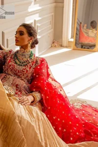 The magic of luxurious romantic outfits at your reception, giving out love and letting it come in. The Beautiful bright red short frock is adorned with classy golden embroidery and will look breathtaking on the traditional bride. The boat shape neckline makes this frock a glamorous choice to pair with the classy golden crushed lehenga. In addition to this, the following frock is enhanced with tilla, dabka, kora, Kundan and the real magic of zardozi. Crushed Lehenga paired with the Embellished frock enhances the overall Royal look of the outfit. The perfect stitching and crushed style make this Lehenga your first-ever priority. Complete this article with a scalloped dupatta that is embellished with four-sided borders and sequins sprayed all over.
