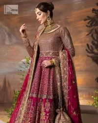 Experience the true essence of reception wear in alluring attires from DeemasFashion. The host pink pishwas is decorated with multiple colour embroidery which is handsomely enhanced with tilla, dabka, kora, Kundan and the real magic of Zardozi to make this masterpiece unique and charming. The finishing of boat shape neckline enhances the beauty of the attire. Furthermore, the full sleeves of the pishwas are a perfectly charming choice to pair with a Pishwas. It is coordinated with a jamawar lehenga whose border is adorned with beautiful embroidery. Complete this article with a dupatta framed with four-sided embellished borders and sequins sprayed all over.