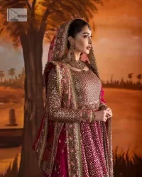 Experience the true essence of reception wear in alluring attires from DeemasFashion. The host pink pishwas is decorated with multiple colour embroidery which is handsomely enhanced with tilla, dabka, kora, Kundan and the real magic of Zardozi to make this masterpiece unique and charming. The finishing of boat shape neckline enhances the beauty of the attire. Furthermore, the full sleeves of the pishwas are a perfectly charming choice to pair with a Pishwas. It is coordinated with a jamawar lehenga whose border is adorned with beautiful embroidery. Complete this article with a dupatta framed with four-sided embellished borders and sequins sprayed all over.