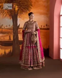 Experience the true essence of reception wear in alluring attires from DeemasFashion. The host pink pishwas is decorated with multiple colour embroidery which is handsomely enhanced with tilla, dabka, kora, Kundan and the real magic of Zardozi to make this masterpiece unique and charming. The finishing of boat shape neckline enhances the beauty of the attire. Furthermore, the full sleeves of the pishwas are a perfectly charming choice to pair with a Pishwas. It is coordinated with a jamawar lehenga whose border is adorned with beautiful embroidery. Complete this article with a dupatta framed with four-sided embellished borders and sequins sprayed all over.