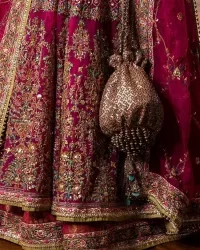 Experience the true essence of reception wear in alluring attires from DeemasFashion. The host pink pishwas is decorated with multiple colour embroidery which is handsomely enhanced with tilla, dabka, kora, Kundan and the real magic of Zardozi to make this masterpiece unique and charming. The finishing of boat shape neckline enhances the beauty of the attire. Furthermore, the full sleeves of the pishwas are a perfectly charming choice to pair with a Pishwas. It is coordinated with a jamawar lehenga whose border is adorned with beautiful embroidery. Complete this article with a dupatta framed with four-sided embellished borders and sequins sprayed all over.