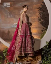 Experience the true essence of reception wear in alluring attires from DeemasFashion. The host pink pishwas is decorated with multiple colour embroidery which is handsomely enhanced with tilla, dabka, kora, Kundan and the real magic of Zardozi to make this masterpiece unique and charming. The finishing of boat shape neckline enhances the beauty of the attire. Furthermore, the full sleeves of the pishwas are a perfectly charming choice to pair with a Pishwas. It is coordinated with a jamawar lehenga whose border is adorned with beautiful embroidery. Complete this article with a dupatta framed with four-sided embellished borders and sequins sprayed all over.