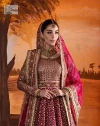 Experience the true essence of reception wear in alluring attires from DeemasFashion. The host pink pishwas is decorated with multiple colour embroidery which is handsomely enhanced with tilla, dabka, kora, Kundan and the real magic of Zardozi to make this masterpiece unique and charming. The finishing of boat shape neckline enhances the beauty of the attire. Furthermore, the full sleeves of the pishwas are a perfectly charming choice to pair with a Pishwas. It is coordinated with a jamawar lehenga whose border is adorned with beautiful embroidery. Complete this article with a dupatta framed with four-sided embellished borders and sequins sprayed all over.