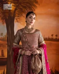 Experience the true essence of reception wear in alluring attires from DeemasFashion. The host pink pishwas is decorated with multiple colour embroidery which is handsomely enhanced with tilla, dabka, kora, Kundan and the real magic of Zardozi to make this masterpiece unique and charming. The finishing of boat shape neckline enhances the beauty of the attire. Furthermore, the full sleeves of the pishwas are a perfectly charming choice to pair with a Pishwas. It is coordinated with a jamawar lehenga whose border is adorned with beautiful embroidery. Complete this article with a dupatta framed with four-sided embellished borders and sequins sprayed all over.