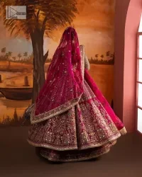 Experience the true essence of reception wear in alluring attires from DeemasFashion. The host pink pishwas is decorated with multiple colour embroidery which is handsomely enhanced with tilla, dabka, kora, Kundan and the real magic of Zardozi to make this masterpiece unique and charming. The finishing of boat shape neckline enhances the beauty of the attire. Furthermore, the full sleeves of the pishwas are a perfectly charming choice to pair with a Pishwas. It is coordinated with a jamawar lehenga whose border is adorned with beautiful embroidery. Complete this article with a dupatta framed with four-sided embellished borders and sequins sprayed all over.