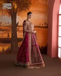 Experience the true essence of reception wear in alluring attires from DeemasFashion. The host pink pishwas is decorated with multiple colour embroidery which is handsomely enhanced with tilla, dabka, kora, Kundan and the real magic of Zardozi to make this masterpiece unique and charming. The finishing of boat shape neckline enhances the beauty of the attire. Furthermore, the full sleeves of the pishwas are a perfectly charming choice to pair with a Pishwas. It is coordinated with a jamawar lehenga whose border is adorned with beautiful embroidery. Complete this article with a dupatta framed with four-sided embellished borders and sequins sprayed all over.