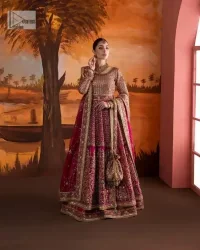 Experience the true essence of reception wear in alluring attires from DeemasFashion. The host pink pishwas is decorated with multiple colour embroidery which is handsomely enhanced with tilla, dabka, kora, Kundan and the real magic of Zardozi to make this masterpiece unique and charming. The finishing of boat shape neckline enhances the beauty of the attire. Furthermore, the full sleeves of the pishwas are a perfectly charming choice to pair with a Pishwas. It is coordinated with a jamawar lehenga whose border is adorned with beautiful embroidery. Complete this article with a dupatta framed with four-sided embellished borders and sequins sprayed all over.