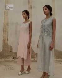 Balancing outfit lovers here’s your style treat! The handsome and charming steel grey attire is an epitome of elegance and royalty that gives you a head-turning appearance on the party occasion. The front open gown is laden with silver embroidery that is further enhanced with tilla, dabka, kora, Kundan and luxuries of crystals. The round neckline of this gown is emblazoned with luxury designs and embroidery. In addition to this, the sleeveless style makes this article a masterpiece. Paired up with straight trousers to balance the look of this exquisite article.