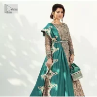 Celebrate your party with a bang and steal everyone's heart. The beautiful blouse in teal green shade comes in organza fabric. The boat shape neckline and full sleeves of this organza blouse are emblazoned with luxury details and intricate designs. Graceful golden embroidery that enhances with tilla, dabka, kora, Kundan, Zardozi and crystals to give a perfect finishing look to the blouse. It is organized with a back train lehenga which is heavily adorned with embroidery to make this masterpiece super aesthetic. Finish this outfit with a scalloped dupatta having four-sided embellished borders for a fine finishing look.