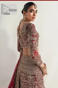 Walk with style at your reception and let the people follow! A stunning wine red blouse is embellished with intricate detailing and finished with light golden embroidery. It is further enhanced with the glorious amalgamation of zardozi, dabka, tilla, and elaborate stonework. Featuring a delicately embellished round neckline highlighted with zardozi detailing. The three-quarter sleeves of the following blouse give this outfit a unique look.  It is paired with a heavily embellished fish-cut lehenga with floral patterns that helps to sustain a traditional craft. Its dupatta is made from wine red net. Enveloping the sequin sprayed dupatta framed with a four-sided border that added divine pleasure to the entire article.