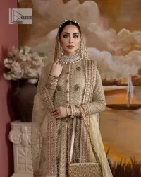 It's where words are not necessary – the outfit does all the talking! A beautiful designed pale green long shirt on an organza base has intricate details of gold, sequin, tilla, dabka, kora and tilla. A contrasting golden embroidery on the round neckline and on full sleeves is the star of the show. Each floral motif is so special, well-researched and strategically put together to create this spellbinding magic using the most gorgeous colour palette. It is paired with brocade lehenga to balance the whole outfit in a golden colour. Last but not least, the mehndi wear has a dupatta which is adorned with a four-sided embellished border in the most stunning way.