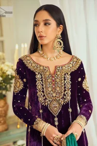 Dress yourself up in glamorous ensembles. DeemasFaashion presents this beautiful party outfit in plum colour. It is highlighted with golden embroidery which is further enhanced with tilla, dabka, kora, Kundan and the real magic of zardozi. The full sleeves are embellished with sequins spray and floral motifs. In addition to this, the embroidered neckline makes this outfit more pretty. It is paired with maroon trousers with beautiful and stunning borders to balance the article. Complete this article with a dupatta in green and plum colour to fulfil the aesthetic look. 