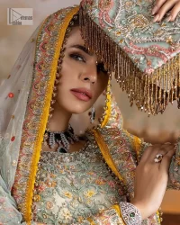 Enhance your beauty by dressing in magic. The most beautiful day of your life deserves an overall dome of embodiment, which is why you need an aqua-blue Anarkali to make you look stunning as a bride. The aqua blue, Anarkali and lehenga are hand-rendered in multiple colour embroidery and are further enhanced with pearls, nakshi, Sitara, tilla, kora, Zardozi and dabka.  The round neckline of the following Anarkali defines the beauty and charm of this unique article. Furthermore, the full sleeves are adorned with floral patterns. It is paired up with lehenga which is ornamented with a heavily embellished border to make this masterpiece unique. Complete this nikah wear with a dupatta adorned with four-sided embellished borders and tiny motifs sprinkled all over.