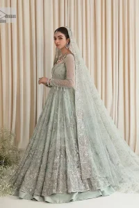 Exquisitely designed ensembles with delicate embroideries & traditional embellishments for nikah outfit statements. This beautiful maxi that comes in aqua blue colour is beautifully embellished with crystals and zardozi work. Beads, motifs,tilla, dabka, sequins, and shimmering adornments enhance the overall charm of this alluring maxi. Perfect stitching and intricate details give a royal appearance to the Bride. The bodice has a delicate and feminine V shape neckline with embellished full sleeves. Paired with lehnga and an alluring dupatta with a heavy spray of sparkling sequins and a detailed head embellished border to make your day super charming.
