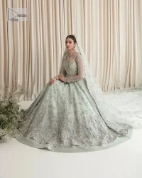 Exquisitely designed ensembles with delicate embroideries & traditional embellishments for nikah outfit statements. This beautiful maxi that comes in aqua blue colour is beautifully embellished with crystals and zardozi work. Beads, motifs,tilla, dabka, sequins, and shimmering adornments enhance the overall charm of this alluring maxi. Perfect stitching and intricate details give a royal appearance to the Bride. The bodice has a delicate and feminine V shape neckline with embellished full sleeves. Paired with lehnga and an alluring dupatta with a heavy spray of sparkling sequins and a detailed head embellished border to make your day super charming.
