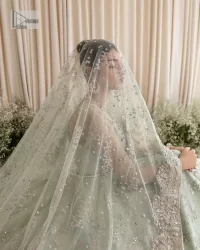 Exquisitely designed ensembles with delicate embroideries & traditional embellishments for nikah outfit statements. This beautiful maxi that comes in aqua blue colour is beautifully embellished with crystals and zardozi work. Beads, motifs,tilla, dabka, sequins, and shimmering adornments enhance the overall charm of this alluring maxi. Perfect stitching and intricate details give a royal appearance to the Bride. The bodice has a delicate and feminine V shape neckline with embellished full sleeves. Paired with lehnga and an alluring dupatta with a heavy spray of sparkling sequins and a detailed head embellished border to make your day super charming.