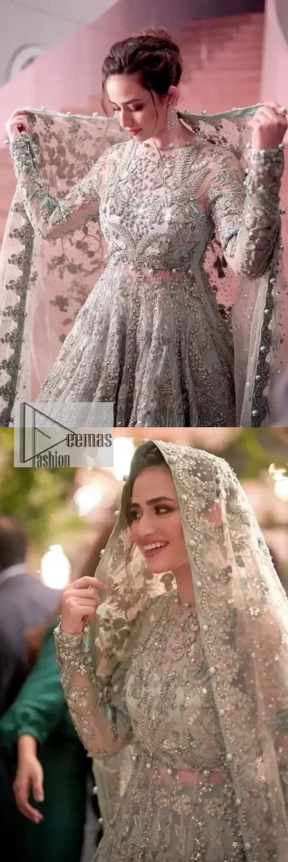 The magic reflects in every piece of this nikah wear. DeemasFashion presents a stunning outfit in an aqua-blue colour. A heavenly designed aqua blue maxi on an organza base serves as a canvas for spellbinding embellishments of gold, tilla, dabka, kora, Kundan and sequins. It is highlighted with silver embroidery to gain the spotlight of the show. The jewel neckline and full sleeves are rendered with beautiful floral patterns and embroidered borders. It is organized with a lehenga in the same colour, adorned with beautiful embroidery giving the perfect final touch. Complete this outfit with a dupatta in the same colour. This dupatta is adorned with floral motifs and silverwork. The embellished borders of this delicate net dupatta make this article your foremost priority.