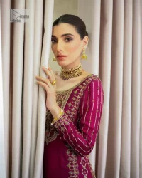 It’s bold, it’s romantic, it’s burgundy. The burgundy shade of this short shirt and gharara makes it an alluring choice for any event. Hand-crafted adornments and designs make this short shirt an epitome of beauty and royalty. The boat shape neckline o the beautiful shirt makes it a perfect choice to pair with the gharara. In addition to this, the beautiful adornments on the sleeves give a glamorous touch to this magnificent attire. It is coordinated with gharara in the same colour. The embellished borders and fine details give a perfect finish to this gharara. Finish this party wear with a dupatta framed with a four-sided border and sparkling tiny floral motifs all over to give a bold look.