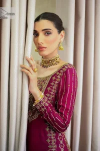 It’s bold, it’s romantic, it’s burgundy. The burgundy shade of this short shirt and gharara makes it an alluring choice for any event. Hand-crafted adornments and designs make this short shirt an epitome of beauty and royalty. The boat shape neckline o the beautiful shirt makes it a perfect choice to pair with the gharara. In addition to this, the beautiful adornments on the sleeves give a glamorous touch to this magnificent attire. It is coordinated with gharara in the same colour. The embellished borders and fine details give a perfect finish to this gharara. Finish this party wear with a dupatta framed with a four-sided border and sparkling tiny floral motifs all over to give a bold look.