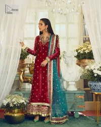 Dreamy details that scream crimson. The day outfits you need to shine your light. DeemasFashion presents this party wear which includes a long shirt, sharara and dupatta. The deep crimson shirt gives that air of regality with its stunning work with hints of tilla, dabka, kora, and Kundan scattered with champagne-mixed stones to balance the tones. The following long silhouette velvet shirt features zari and zardozi embroidery details on the embellished neckline. Further, the full sleeves are also decorated with floral motifs. It is systemized with sharara in the same colour to balance the royal look. Finish this article with a dupatta in green colour which is adorned with tiny floral motifs all over to brighten the day.