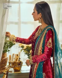 Dreamy details that scream crimson. The day outfits you need to shine your light. DeemasFashion presents this party wear which includes a long shirt, sharara and dupatta. The deep crimson shirt gives that air of regality with its stunning work with hints of tilla, dabka, kora, and Kundan scattered with champagne-mixed stones to balance the tones. The following long silhouette velvet shirt features zari and zardozi embroidery details on the embellished neckline. Further, the full sleeves are also decorated with floral motifs. It is systemized with sharara in the same colour to balance the royal look. Finish this article with a dupatta in green colour which is adorned with tiny floral motifs all over to brighten the day.