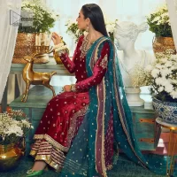 Dreamy details that scream crimson. The day outfits you need to shine your light. DeemasFashion presents this party wear which includes a long shirt, sharara and dupatta. The deep crimson shirt gives that air of regality with its stunning work with hints of tilla, dabka, kora, and Kundan scattered with champagne-mixed stones to balance the tones. The following long silhouette velvet shirt features zari and zardozi embroidery details on the embellished neckline. Further, the full sleeves are also decorated with floral motifs. It is systemized with sharara in the same colour to balance the royal look. Finish this article with a dupatta in green colour which is adorned with tiny floral motifs all over to brighten the day.