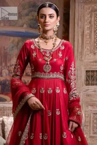 The traditional style is the new thing in the market. The stunning pishwas in the deep red shade is an eye-catching attire that gives you your desired dreamy appearance on your Big day. Beautiful work of zardozi, tilla, dabka, kora, Kundan, pearls, and beads make this attire an epitome of glamour and royalty. Embellished borders, as well as the bodice, gives an enchanting touch to this pishwas. Further, the round neckline of the outfit gives a royal touch. Further, fancy floral motifs are also adorned on the sleeves of this reception wear. It is organized with a dupatta framed with a four-sided border and sparkling tiny floral motifs all over.