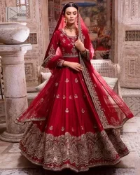 The traditional style is the new thing in the market. The stunning pishwas in the deep red shade is an eye-catching attire that gives you your desired dreamy appearance on your Big day. Beautiful work of zardozi, tilla, dabka, kora, Kundan, pearls, and beads make this attire an epitome of glamour and royalty. Embellished borders, as well as the bodice, gives an enchanting touch to this pishwas. Further, the round neckline of the outfit gives a royal touch. Further, fancy floral motifs are also adorned on the sleeves of this reception wear. It is organized with a dupatta framed with a four-sided border and sparkling tiny floral motifs all over.