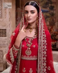 The traditional style is the new thing in the market. The stunning pishwas in the deep red shade is an eye-catching attire that gives you your desired dreamy appearance on your Big day. Beautiful work of zardozi, tilla, dabka, kora, Kundan, pearls, and beads make this attire an epitome of glamour and royalty. Embellished borders, as well as the bodice, gives an enchanting touch to this pishwas. Further, the round neckline of the outfit gives a royal touch. Further, fancy floral motifs are also adorned on the sleeves of this reception wear. It is organized with a dupatta framed with a four-sided border and sparkling tiny floral motifs all over.