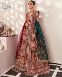 This deep rust outfit with a floral pattern has you covered for your big day. This deep rust angrakha is hand rendered in shades of multiple colours. The angrakha is decorated with gota, nakshi, dabka, and tilla in contrasting colours and is attached to hand-embellished panels. Further, the V shape neckline makes this masterpiece unique and priceless. The full sleeves of the following angrakha are a delightful way to add beauty to this mehndi wear. It is paired with a lehenga in the same colour having embroidered borders. Complete this traditional outfit with a dupatta in the green colour which is adorned with a four-sided Kiran and sequins sprayed all over.