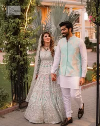 Brighten up your big day with this beautiful ensemble - Perfectly suited to the trend! DeemasFashion presents this nikah wear in the shade of ice blue. This stunning maxi has a fully embellished square neckline and full sleeves. Graceful multiple-colour work and floral designs enhance the charm of this maxi. Zardozi, pearls, dabka, kora, Kundan, and stones give a perfect finish to the overall look. The flares of the following maxi make it your foremost priority to wear on the most important day of your life. Paired this with a dupatta which is adorned with a four sided embellished borders and sequins sprayed all over to make this look more charming and perfect.