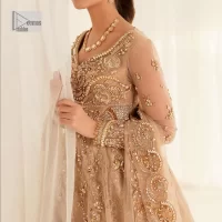 Presenting elegance personified glamorous formal nikah outfit. A heavenly-designed light golden maxi on an organza base serves as a canvas for spellbinding embellishments of antique gold, tilla, dabka, kora, Kundan and sequins. The sweetheart neckline makes this outfit unique and priceless. Furthermore, the following flawed maxi has three-quarter sleeves. It is paired with a plain lehenga and a dupatta in the same colour. The dupatta is adorned with carefully placed sequin spray and embellished four-sided borders for more calm and charm.