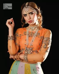 Fun colours, fresh you.  This breathtaking blouse in light orange colour is gracefully adorned with hand-crafted embellishments and lavish golden work creating a magnificent masterpiece to give you your desired appearance. The boat shape neckline of the mehndi wear is the epitome of beauty. Further, the embellished three-quarter is adorned with lavish designs and fine details making it a perfect choice to pair with the lehenga. It is organized with lehenga having multi-colour panels to give you a fresh and rainbow look on your mehndi. The lehenga is also adorned with tilla, dabka, kora, Kundan and the real magic of Zardozi. Complete this article with a dupatta, framed with four-sided borders and floral motifs on pallu to make your day Funday.