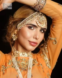 Fun colours, fresh you.  This breathtaking blouse in light orange colour is gracefully adorned with hand-crafted embellishments and lavish golden work creating a magnificent masterpiece to give you your desired appearance. The boat shape neckline of the mehndi wear is the epitome of beauty. Further, the embellished three-quarter is adorned with lavish designs and fine details making it a perfect choice to pair with the lehenga. It is organized with lehenga having multi-colour panels to give you a fresh and rainbow look on your mehndi. The lehenga is also adorned with tilla, dabka, kora, Kundan and the real magic of Zardozi. Complete this article with a dupatta, framed with four-sided borders and floral motifs on pallu to make your day Funday.