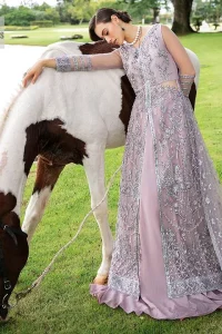 Lilac article on your Big day is like a pro. This lilac front open gown in the lilac shade is the epitome of royalty and grace. The gorgeous gown is adorned with silver dabka, pearls,tilla, kora, Kundan, zardozi and the real magic of beads. It is prominent with silver embroidery. The following gown has a V shape neckline to make this outfit remarkable. Further, the beautiful embroidery is adorned on full sleeves. The fully embellished lilac Gown will look perfect when paired with a set of plain lehenga choli. It is organized with a dupatta framed with four-sided borders and tiny floral motifs all over to gain pro magic.