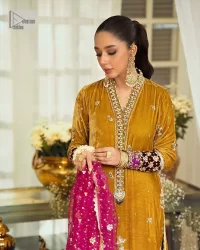 This mustard ensemble features zari and tilla details creating the perfect magical look for the season! The stunning long shirt in an alluring mustard shade comes in velvet fabric. The V-neckline of this shirt is emblazoned with embroidery and hand-crafted embellishments. Motifs, tilla, and threads give a perfect finishing look to the shirt. It is enhanced with multiple colours embroidered patches at the bottom to stole everyone's heart. It is paired with scalloped burgundy trousers to balance the overall look of this party wear. Complete this with a dupatta having tiny floral motifs and sequins sprayed all over.