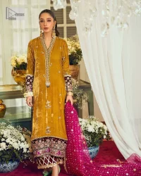 This mustard ensemble features zari and tilla details creating the perfect magical look for the season! The stunning long shirt in an alluring mustard shade comes in velvet fabric. The V-neckline of this shirt is emblazoned with embroidery and hand-crafted embellishments. Motifs, tilla, and threads give a perfect finishing look to the shirt. It is enhanced with multiple colours embroidered patches at the bottom to stole everyone's heart. It is paired with scalloped burgundy trousers to balance the overall look of this party wear. Complete this with a dupatta having tiny floral motifs and sequins sprayed all over.