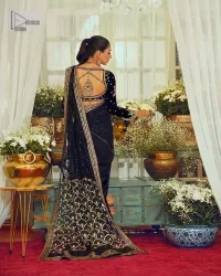 Black, is a reminder to love yourself. The navy blue blouse is augmented with elusive dabka and remarkable naqshi to highlight the grace and is further enhanced with tilla, dabka, koran and Kundan.  The V shape neckline of the following blouse is beautifully decorated with multiple colour embroidery. In addition to this, the heavy floral motifs also adorned the full sleeves to add more charm and beauty to this party wear. It is paired with a black saree to style you according to your choice. Complex work on the borders and the pallu makes it look even more gorgeous. This is a beautiful piece for a bridesmaid who has traditional taste.
