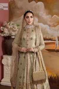 It's where words are not necessary – the outfit does all the talking! A beautiful designed pale green long shirt on an organza base has intricate details of gold, sequin, tilla, dabka, kora and tilla. A contrasting golden embroidery on the round neckline and on full sleeves is the star of the show. Each floral motif is so special, well-researched and strategically put together to create this spellbinding magic using the most gorgeous colour palette. It is paired with brocade lehenga to balance the whole outfit in a golden colour. Last but not least, the mehndi wear has a dupatta which is adorned with a four-sided embellished border in the most stunning way.