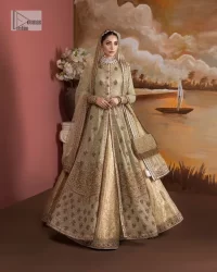 It's where words are not necessary – the outfit does all the talking! A beautiful designed pale green long shirt on an organza base has intricate details of gold, sequin, tilla, dabka, kora and tilla. A contrasting golden embroidery on the round neckline and on full sleeves is the star of the show. Each floral motif is so special, well-researched and strategically put together to create this spellbinding magic using the most gorgeous colour palette. It is paired with brocade lehenga to balance the whole outfit in a golden colour. Last but not least, the mehndi wear has a dupatta which is adorned with a four-sided embellished border in the most stunning way.