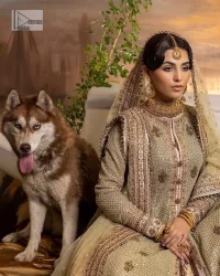 It's where words are not necessary – the outfit does all the talking! A beautiful designed pale green long shirt on an organza base has intricate details of gold, sequin, tilla, dabka, kora and tilla. A contrasting golden embroidery on the round neckline and on full sleeves is the star of the show. Each floral motif is so special, well-researched and strategically put together to create this spellbinding magic using the most gorgeous colour palette. It is paired with brocade lehenga to balance the whole outfit in a golden colour. Last but not least, the mehndi wear has a dupatta which is adorned with a four-sided embellished border in the most stunning way.