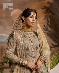 It's where words are not necessary – the outfit does all the talking! A beautiful designed pale green long shirt on an organza base has intricate details of gold, sequin, tilla, dabka, kora and tilla. A contrasting golden embroidery on the round neckline and on full sleeves is the star of the show. Each floral motif is so special, well-researched and strategically put together to create this spellbinding magic using the most gorgeous colour palette. It is paired with brocade lehenga to balance the whole outfit in a golden colour. Last but not least, the mehndi wear has a dupatta which is adorned with a four-sided embellished border in the most stunning way.